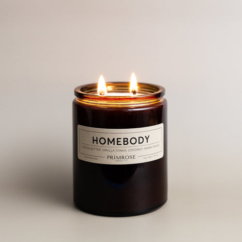 Cocoa Butter, Vanilla, Tonka, Coconut, Warm Spices  Providing a cozy and comforting ambiance, Homebody is the perfect warm scent. The complexity of warm spices, rich cocoa butter, olive wood and a touch of coconut sweetness combines to create the most relaxing fragrance, perfect for those of us who relish cancelled plans and nights in.  - 15 ounces