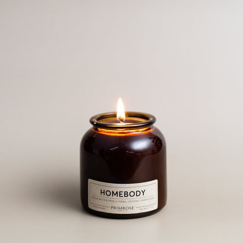 Cocoa Butter, Vanilla, Tonka, Coconut, Warm Spices  Providing a cozy and comforting ambiance, Homebody is the perfect warm scent. The complexity of warm spices, rich cocoa butter, olive wood and a touch of coconut sweetness combines to create the most relaxing fragrance, perfect for those of us who relish cancelled plans and nights in.